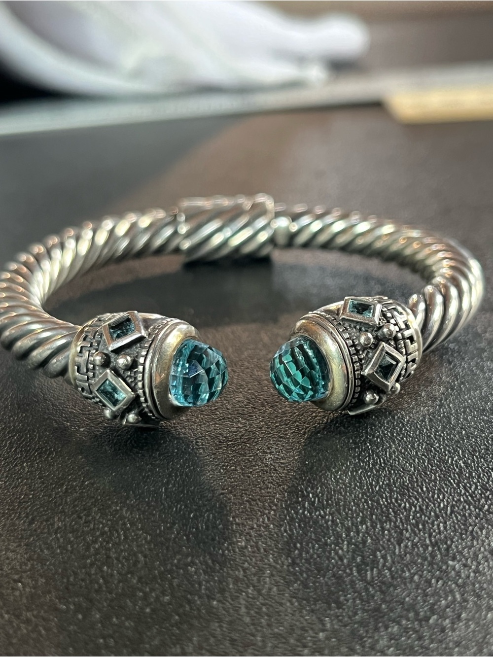Sterling silver twisted cable cuff bangle w/blue topaz stones.
